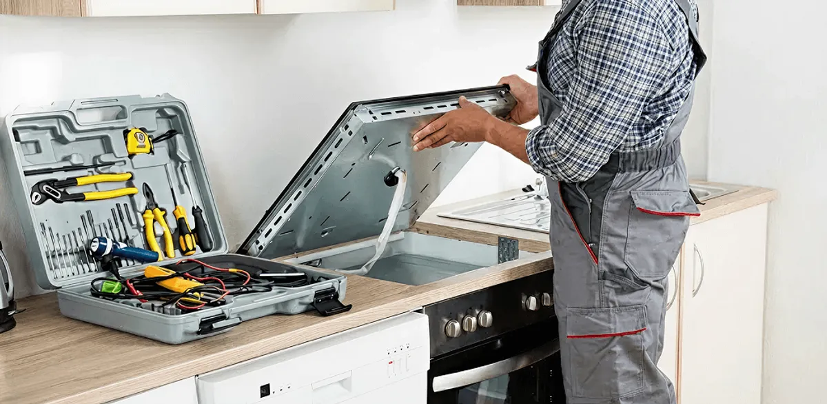 Handyman repairing a cooktop and checking wiring connections in Green Bay, WI