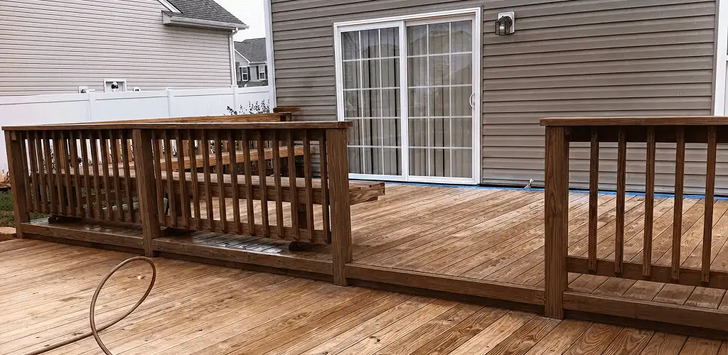 Deck sealing service protecting a backyard wood deck and railings in Green Bay, WI