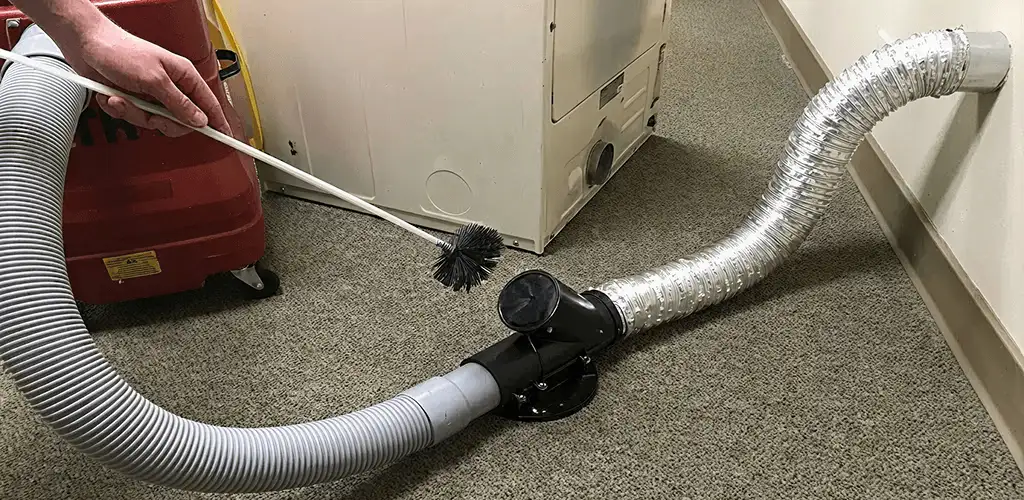 Dryer vent cleaning service removing lint from a dryer duct connection in Green Bay, WI