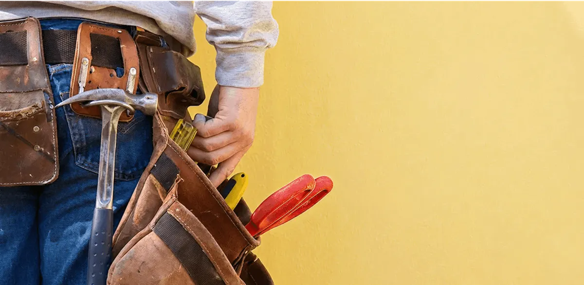 Handyman with tool belt ready for home repairs and maintenance in Green Bay, WI