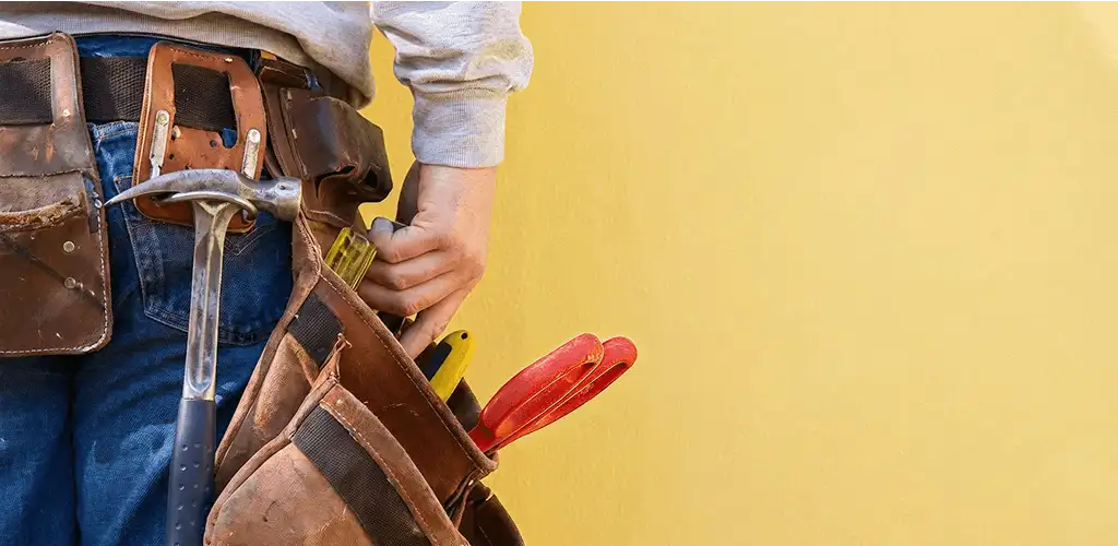 Handyman with tool belt ready for home repairs and maintenance in Green Bay, WI