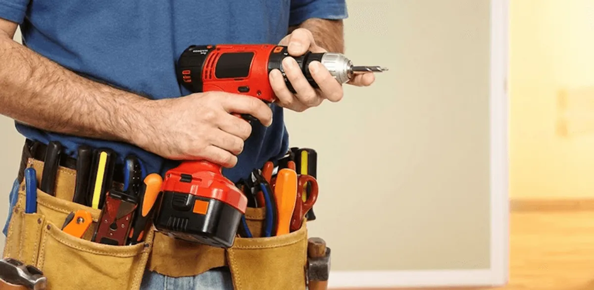Handyman holding a power drill for home repairs and installations in Green Bay, WI