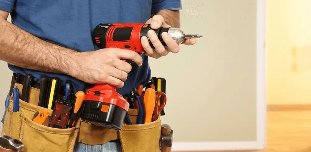 Handyman holding a power drill for home repairs and installations in Green Bay, WI