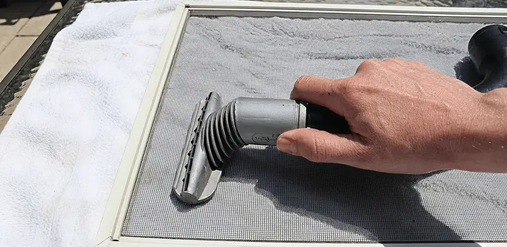 Window screen repair cleaning and fixing a damaged screen mesh in Green Bay, WI