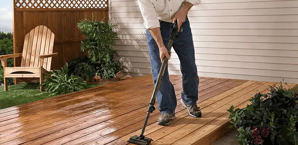 Deck staining service applying stain to a backyard wood deck in Green Bay, WI